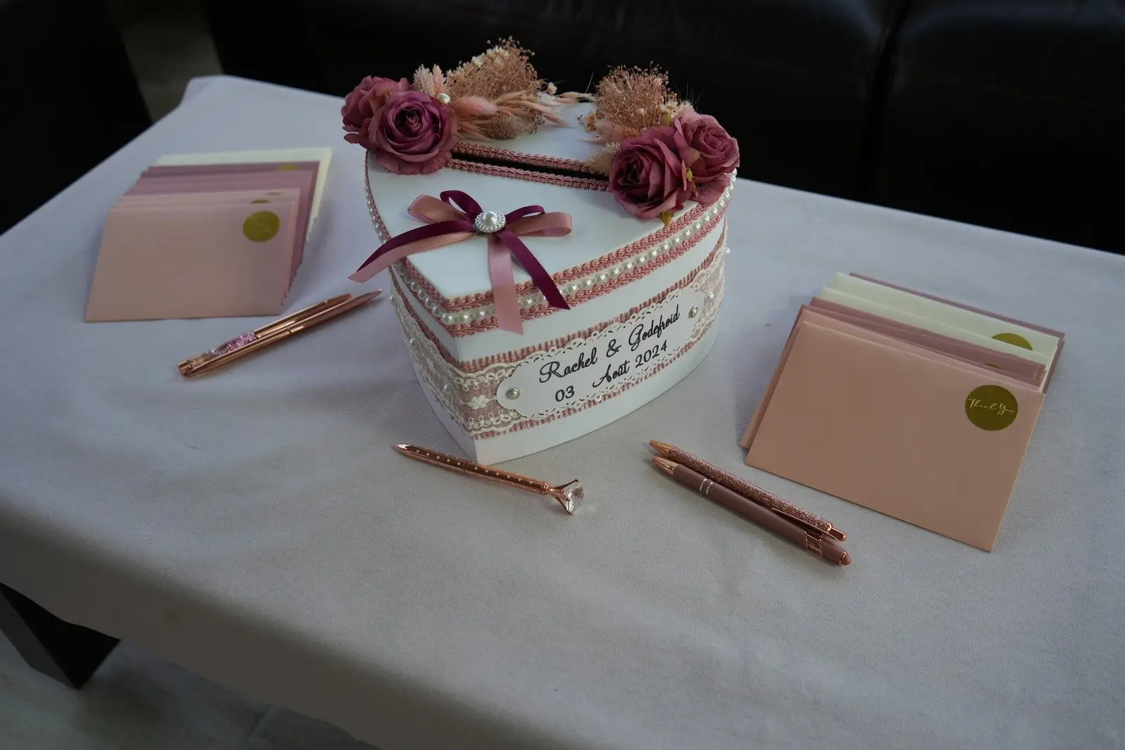 Coffret cadeau contenant des stylos et carnets, posé sur une table.